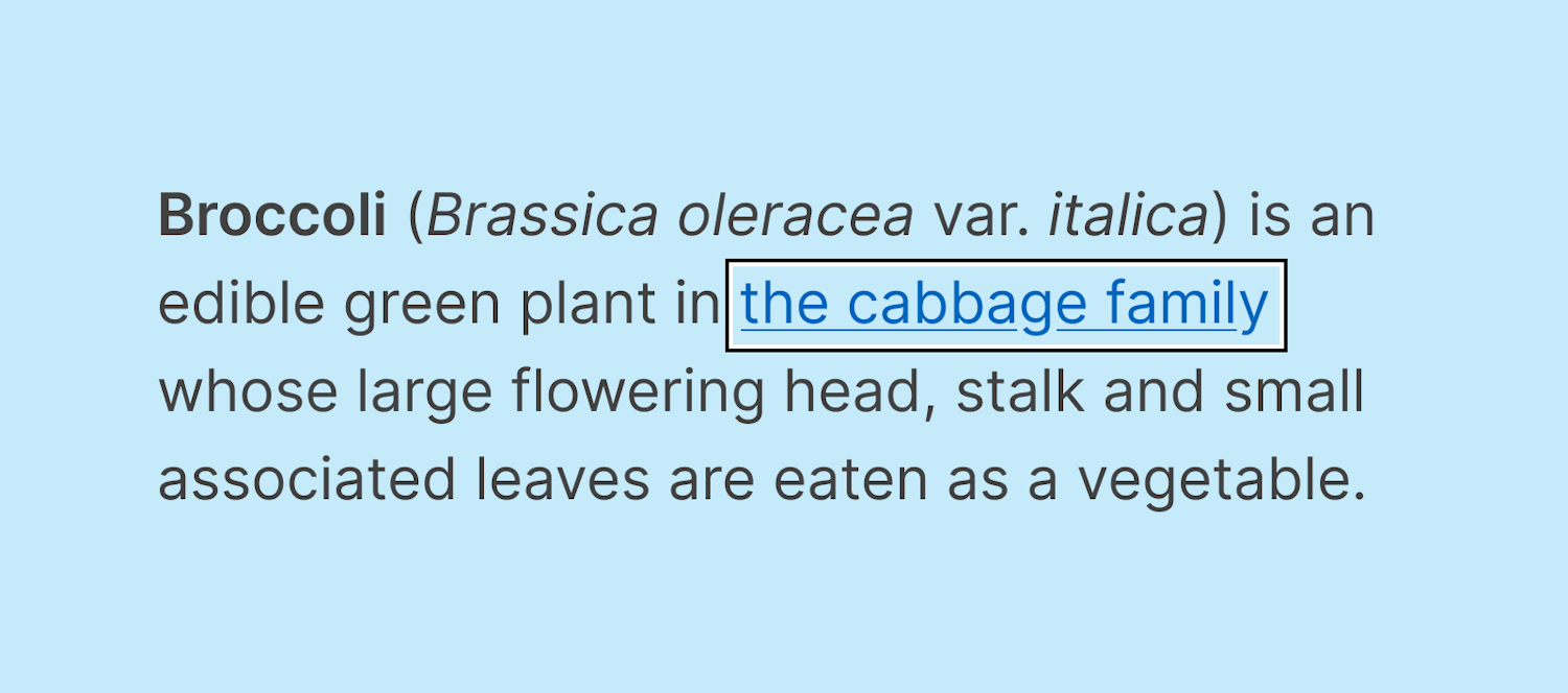 Two rings identifying a focused link in a sentence. The outer ring is black and the inner ring is white. The background is a light blue color, making the white outline difficult to see. The link reads, “the cabbage family”, and the full sentence reads, “Broccoli (Brassica oleracea var. italica) is an edible green plant in the cabbage family whose large flowering head, stalk and small associated leaves are eaten as a vegetable.”