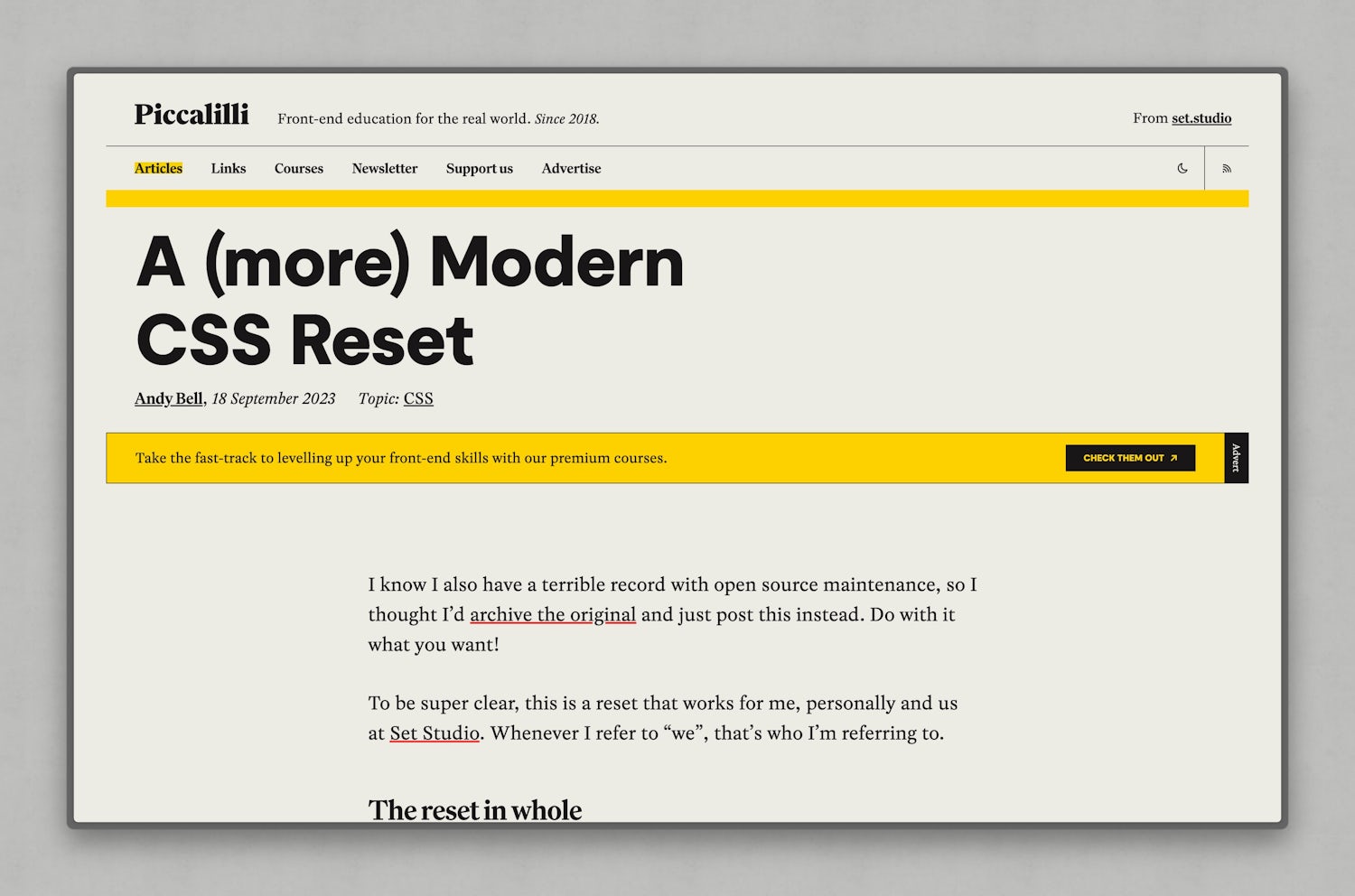 The top of the "A (more) modern reset article" showing a bright yellow banner that features text, a black button and rotated "advert" text