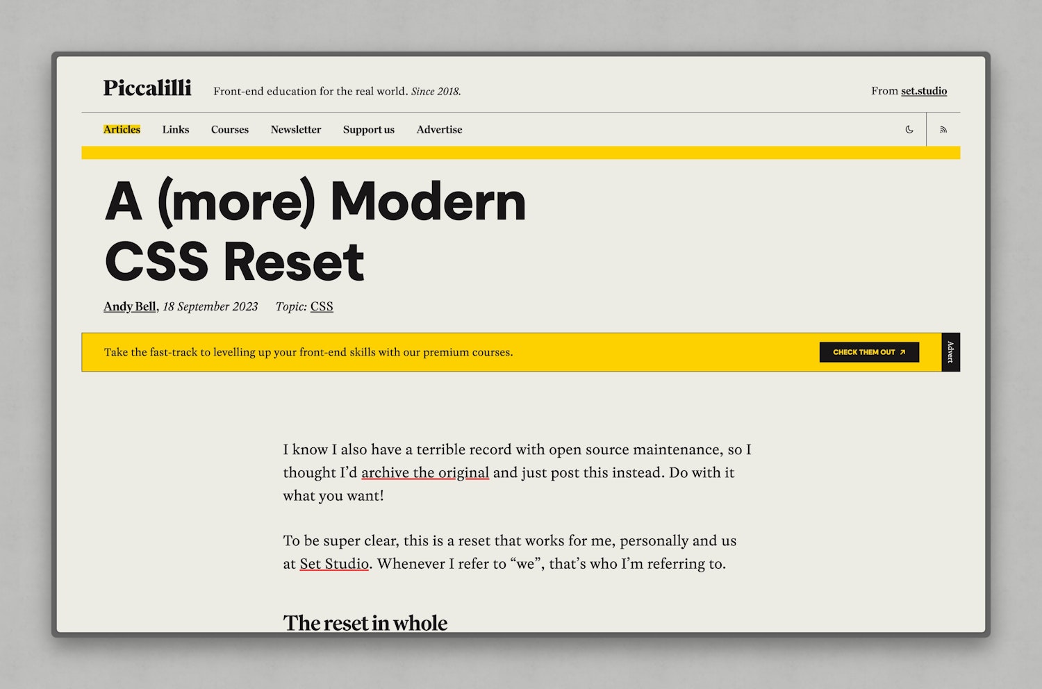 The top of the "A (more) modern reset article" showing a bright yellow banner that features text, a black button and rotated "advert" text